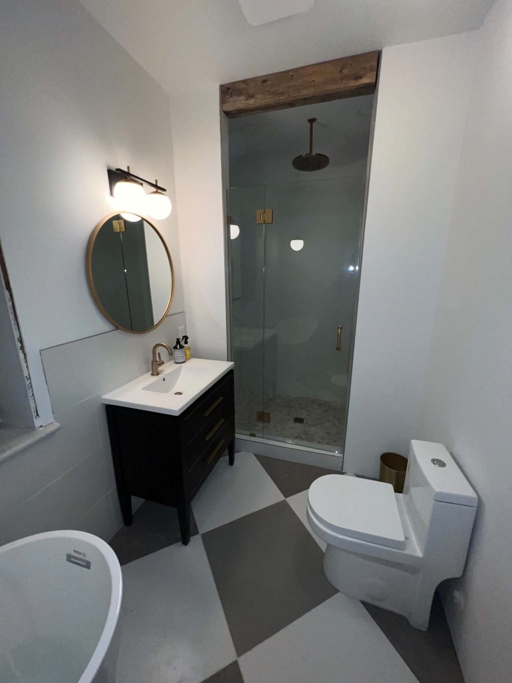 Finished bathroom with glass shower enclosure and one-piece toilet